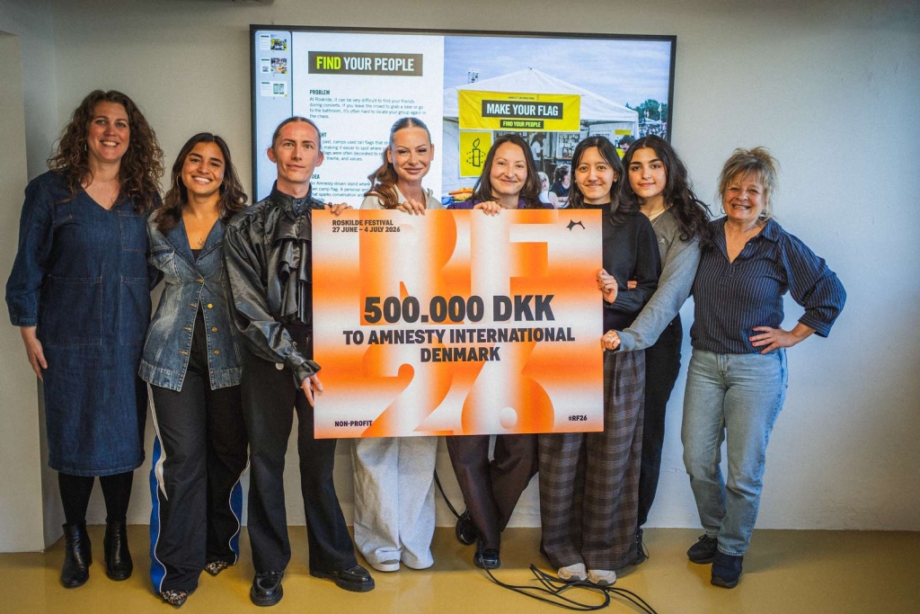 Tessa overrækker donationen fra Roskilde Festival til Amnesty Internationel.